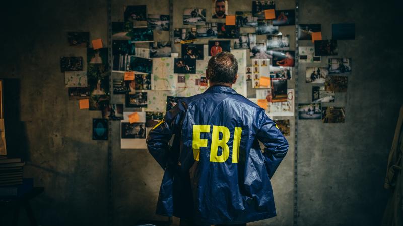 FBI Agent looks over evidence 