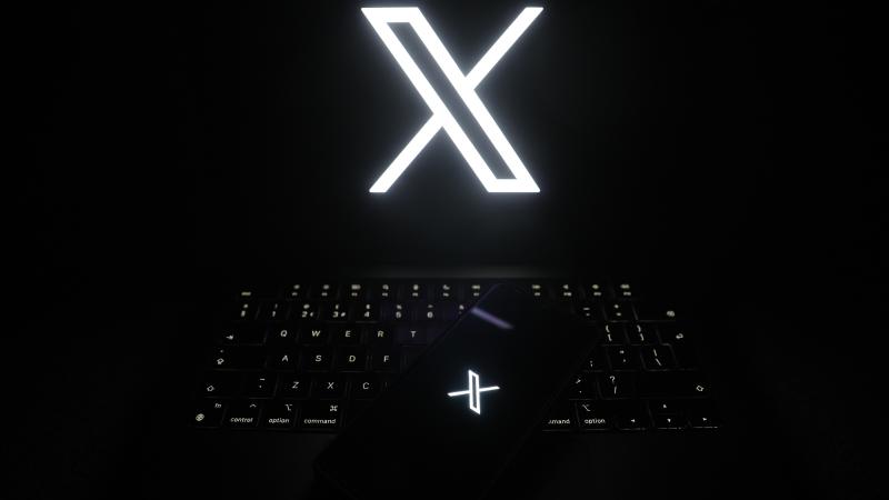 The logo of online social media site 'X' (formerly known as Twitter) is displayed on a smartphone and laptop